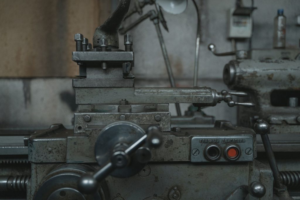 Close-up of an antique lathe showcasing tools and machinery in a vintage workshop.