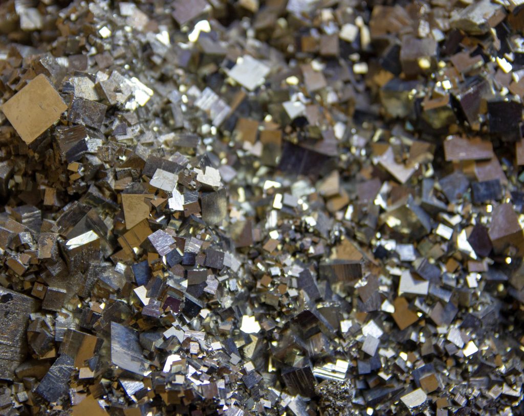 Detailed view of shiny pyrite crystals showcasing intricate metallic textures and patterns.